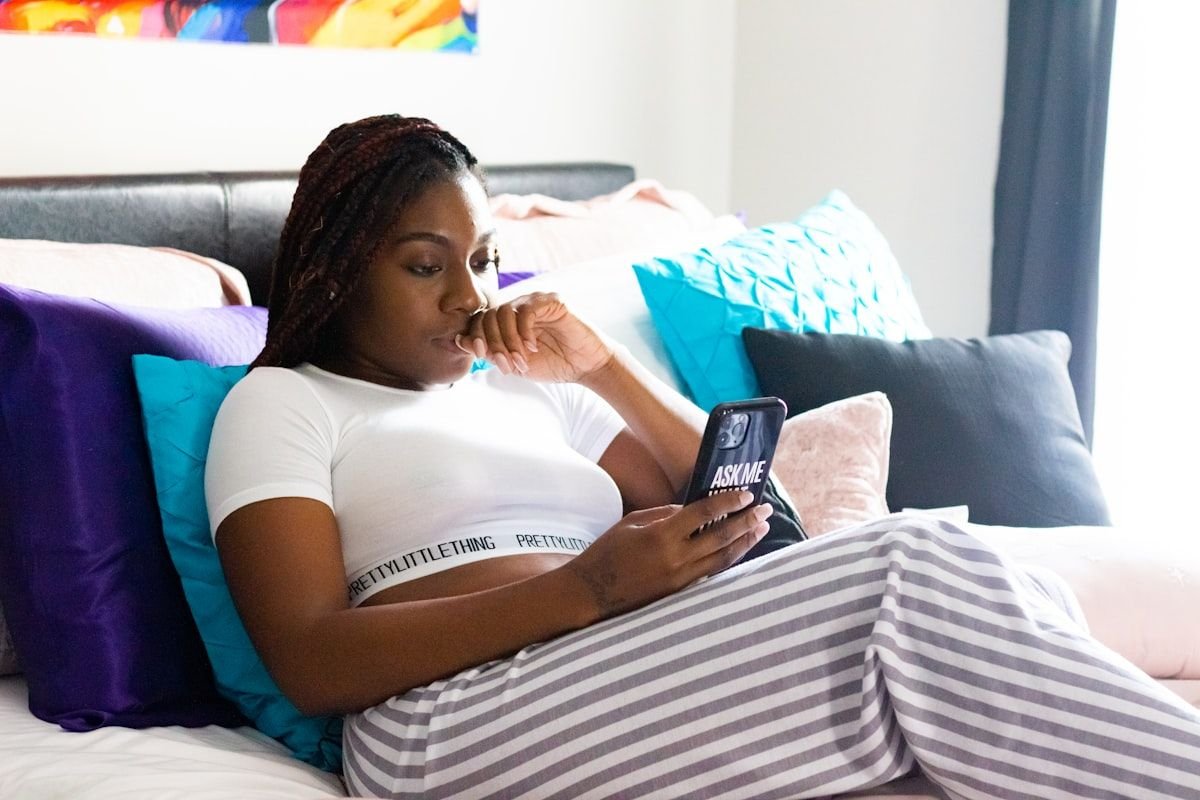 NFN meaning in text considered by a woman reading an unexpected message on her phone in bed